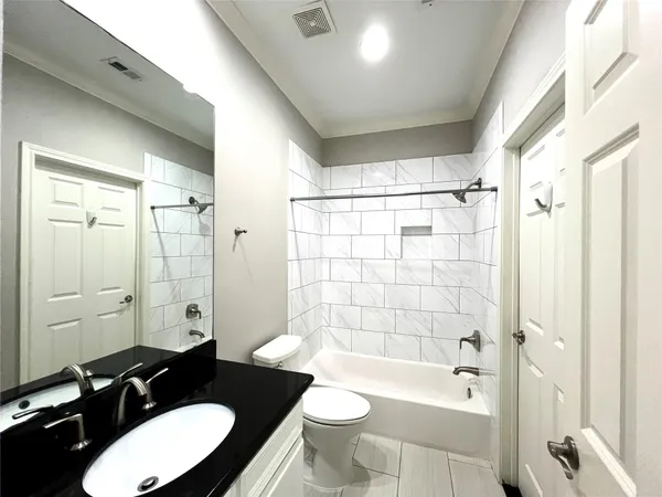 an empty room with wooden floor and windows with curtains