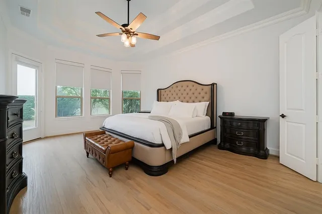 a bedroom with a bed and a large window