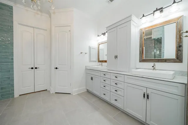 a bathroom with double sink and a mirror