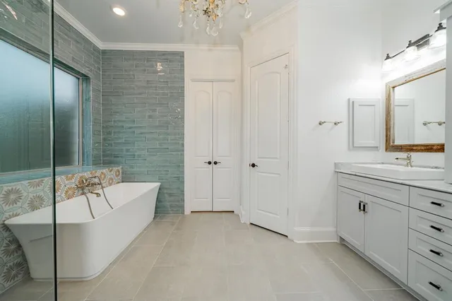 a bathroom with a tub sink and mirror