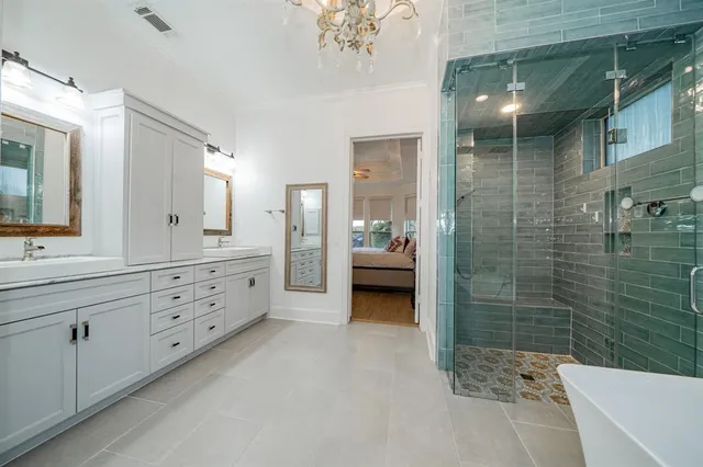 a bathroom with a double vanity sink toilet and shower