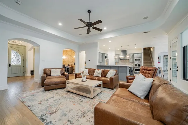 a living room with furniture and a chandelier