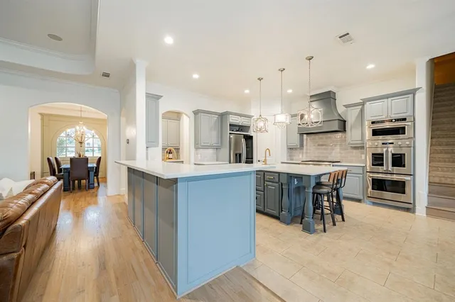 a large kitchen with a table and chairs in it