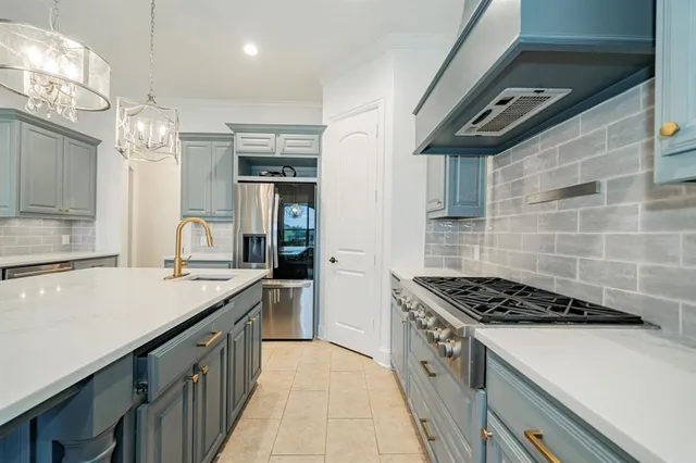 a kitchen that has a sink and a stove