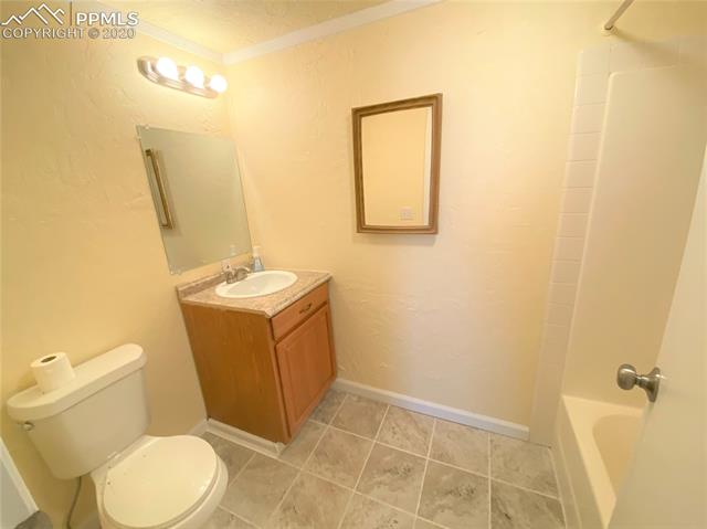3255 Wiesner Road Calhan, CO 80808 - Photo 21 of 25 Private Master Bathroom (includes New Interior Paint, New Tile Flooring, New Lighting Fixtures, New Mirror & Vent Fan, newer faucet, newer shower fixtures.)