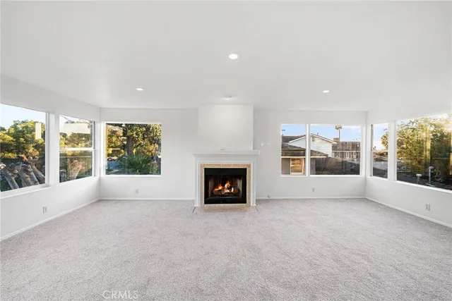 a view of an empty room with a fireplace and a window