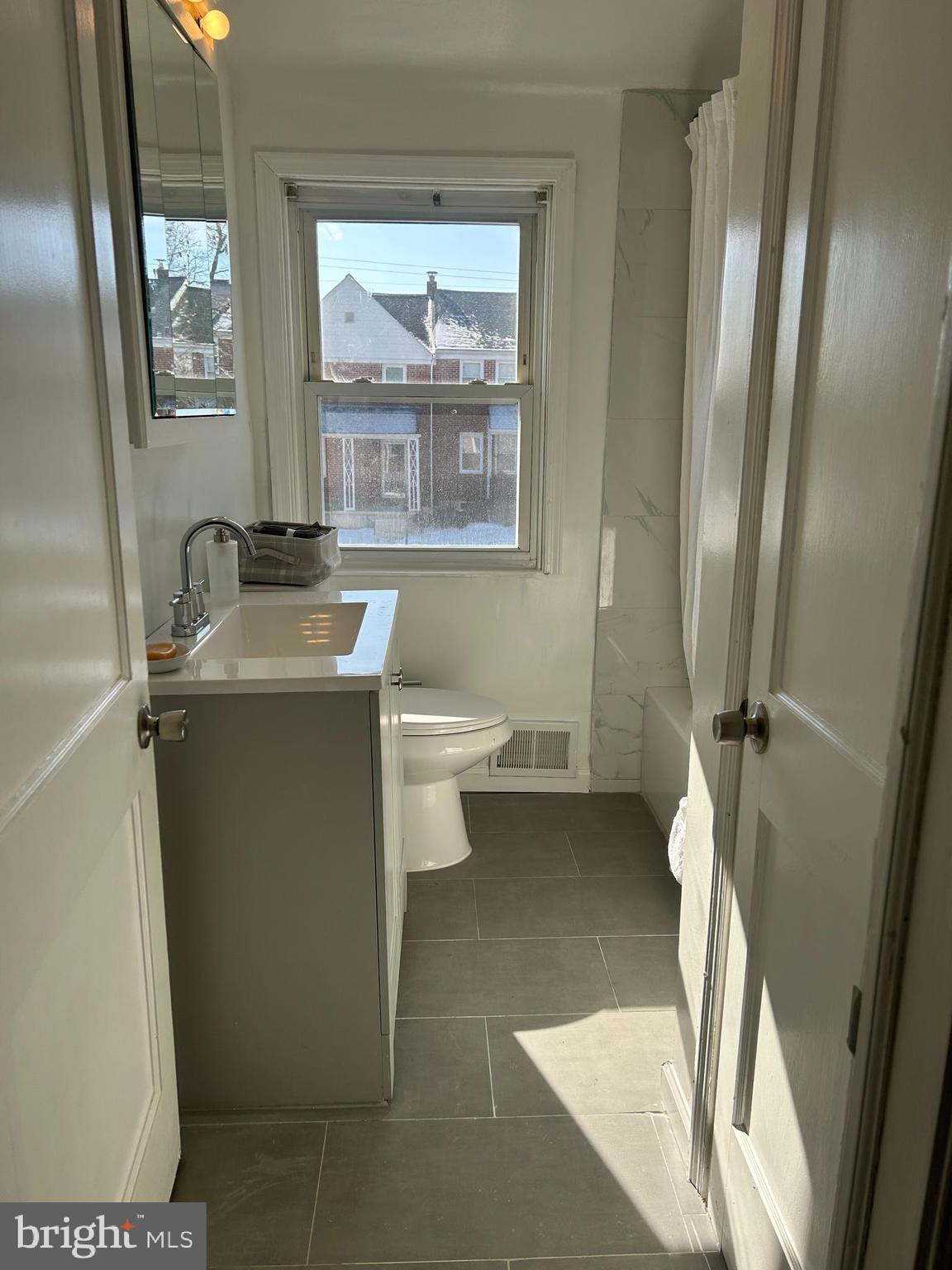 603 Braeside Road Baltimore, MD 21229 - Photo 19 of 30 a bathroom with a sink toilet and mirror