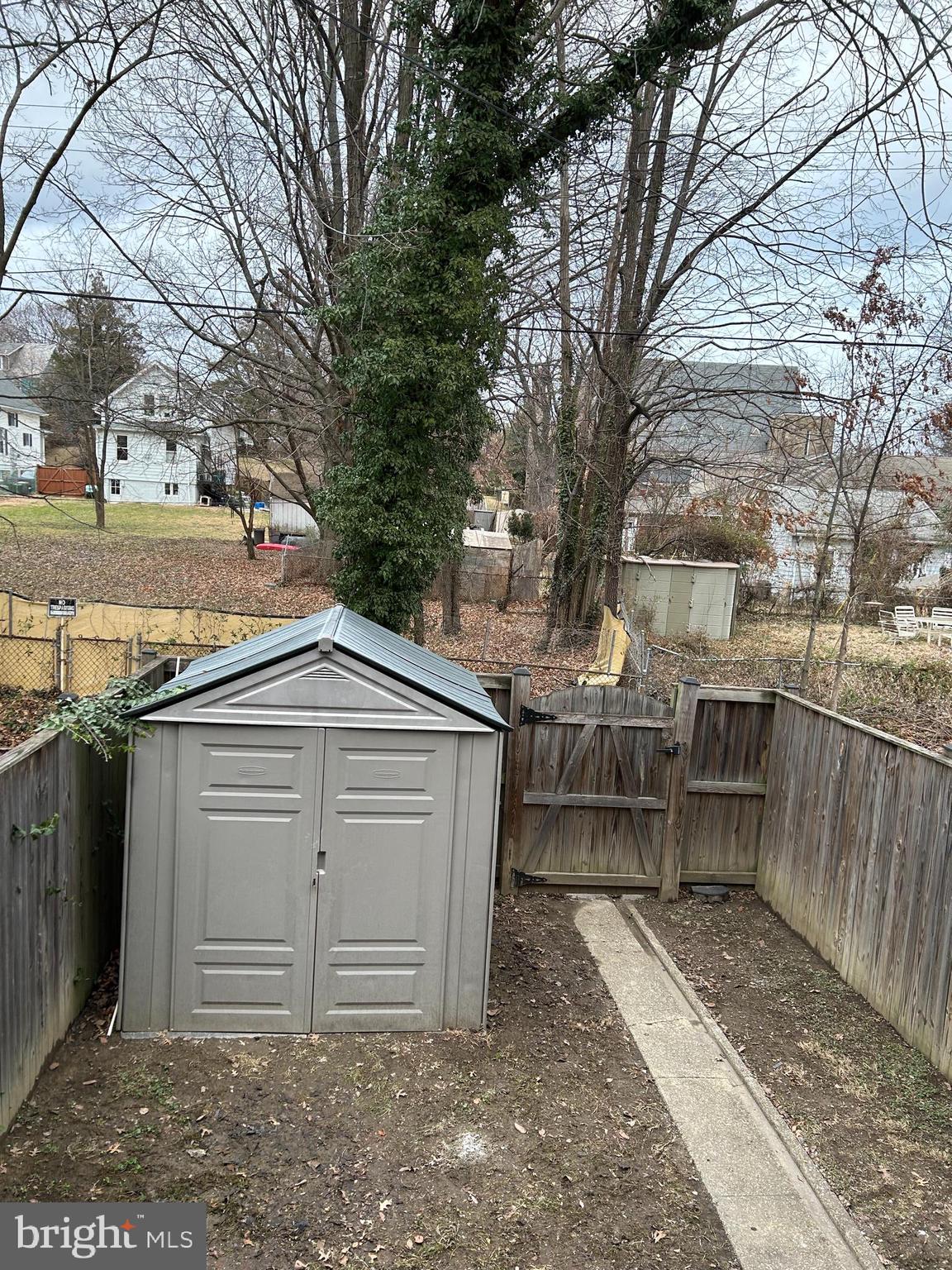603 Braeside Road Baltimore, MD 21229 - Photo 27 of 30 a view of a garage with wooden fence and large trees