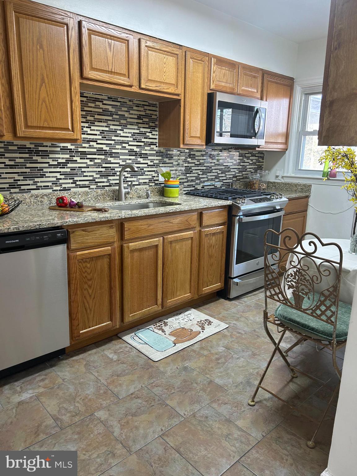 603 Braeside Road Baltimore, MD 21229 - Photo 7 of 30 a kitchen with stainless steel appliances granite countertop a stove sink and cabinets