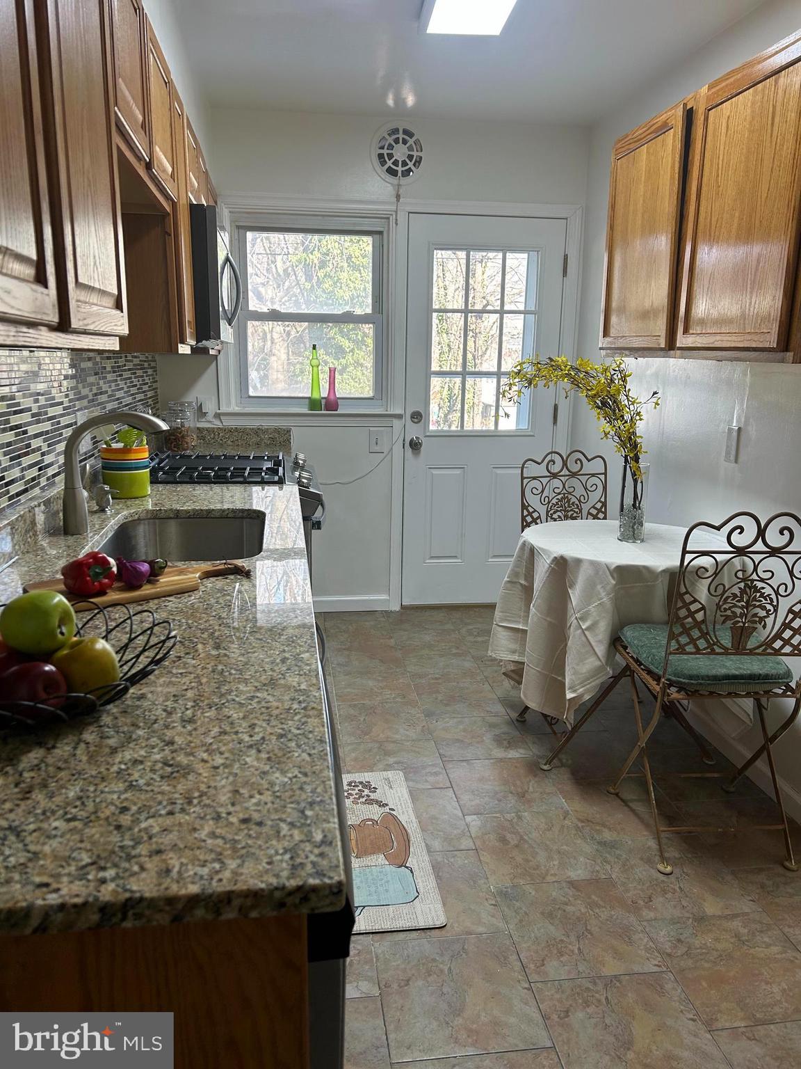 603 Braeside Road Baltimore, MD 21229 - Photo 8 of 30 a kitchen with a stove a sink and a counter space