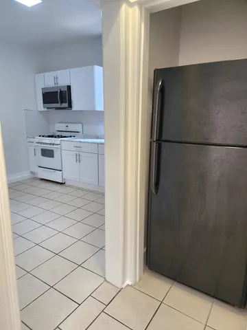 a kitchen with stainless steel appliances a refrigerator and a stove top oven