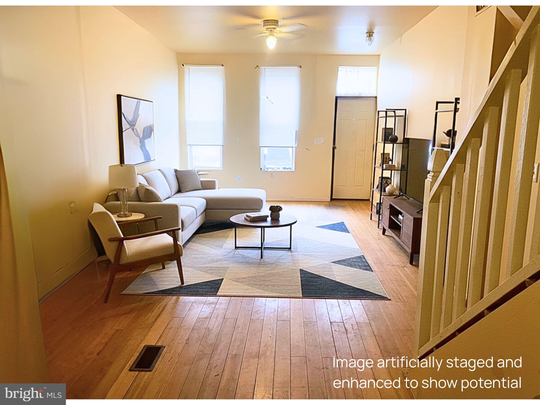 a living room with furniture and a wooden floor