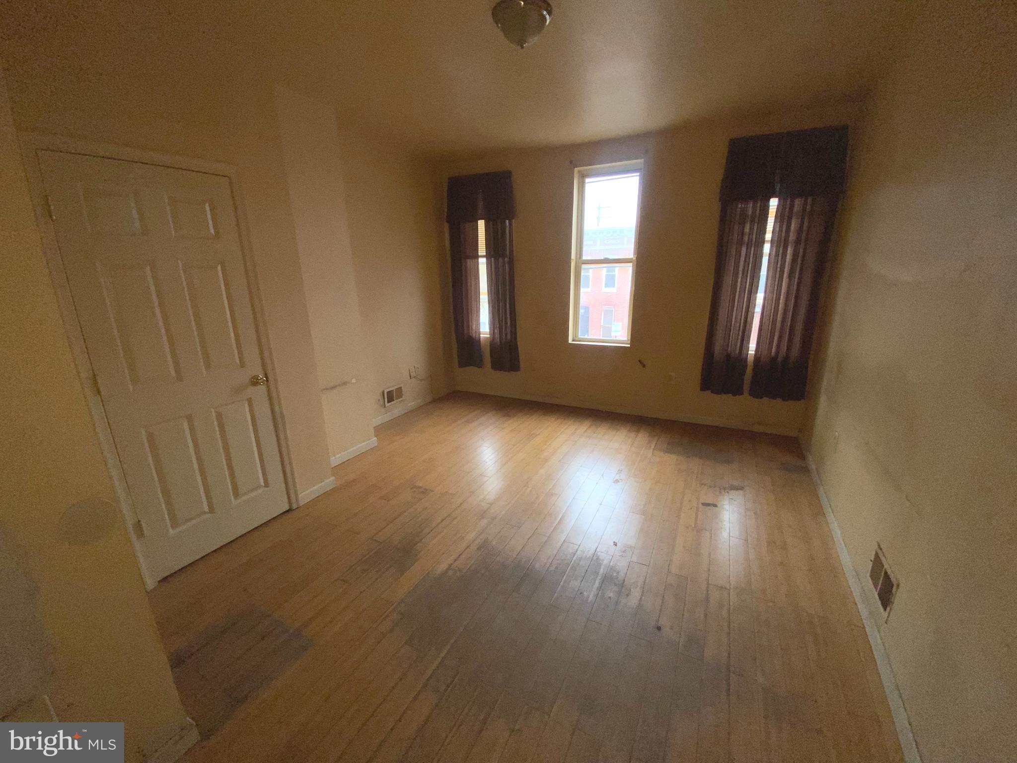 2221 Jefferson Street Baltimore, MD 21205 - Photo 11 of 29 a view of an empty room with wooden floor and a window