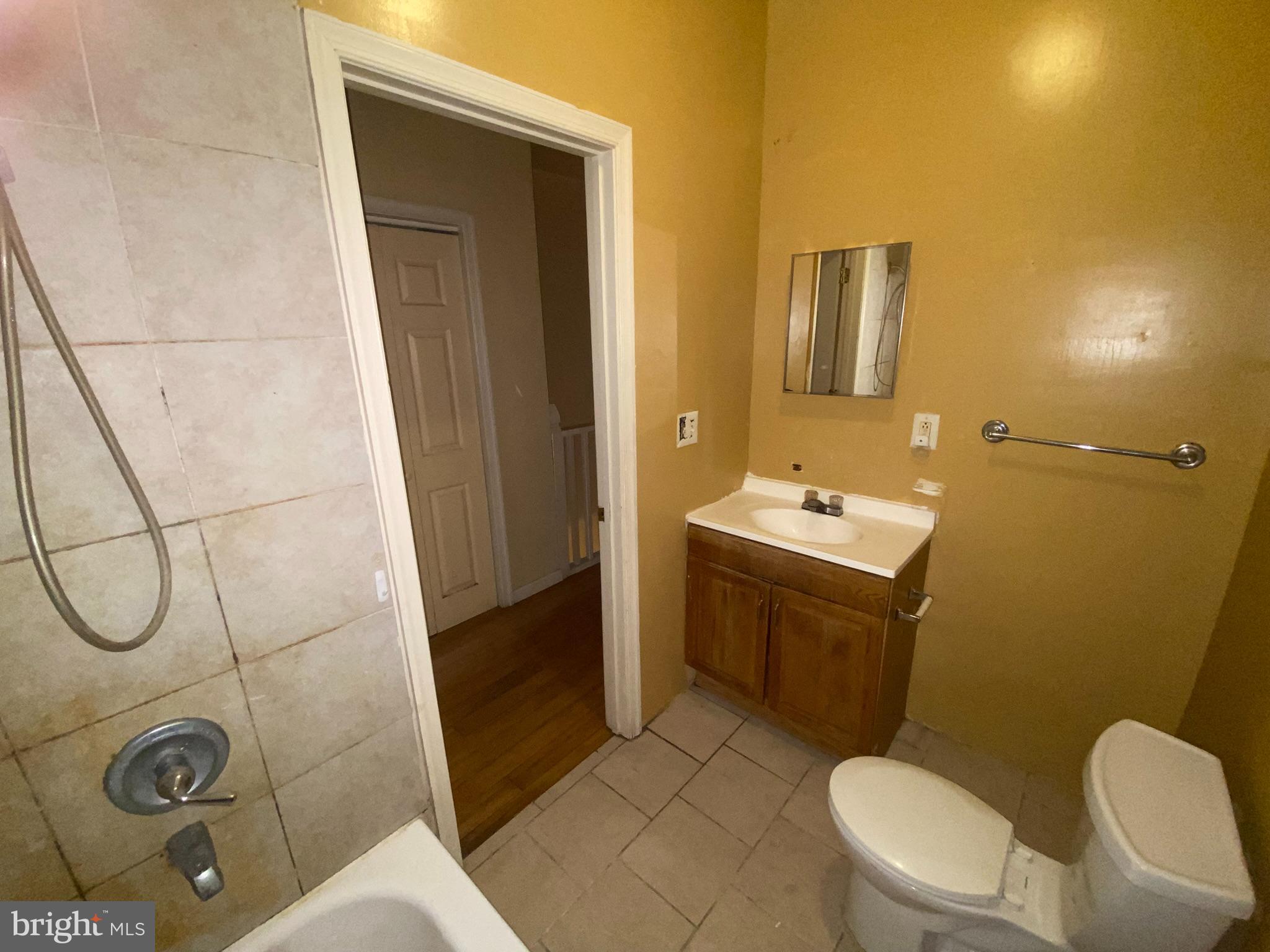 2221 Jefferson Street Baltimore, MD 21205 - Photo 13 of 29 a bathroom with a sink a toilet and shower