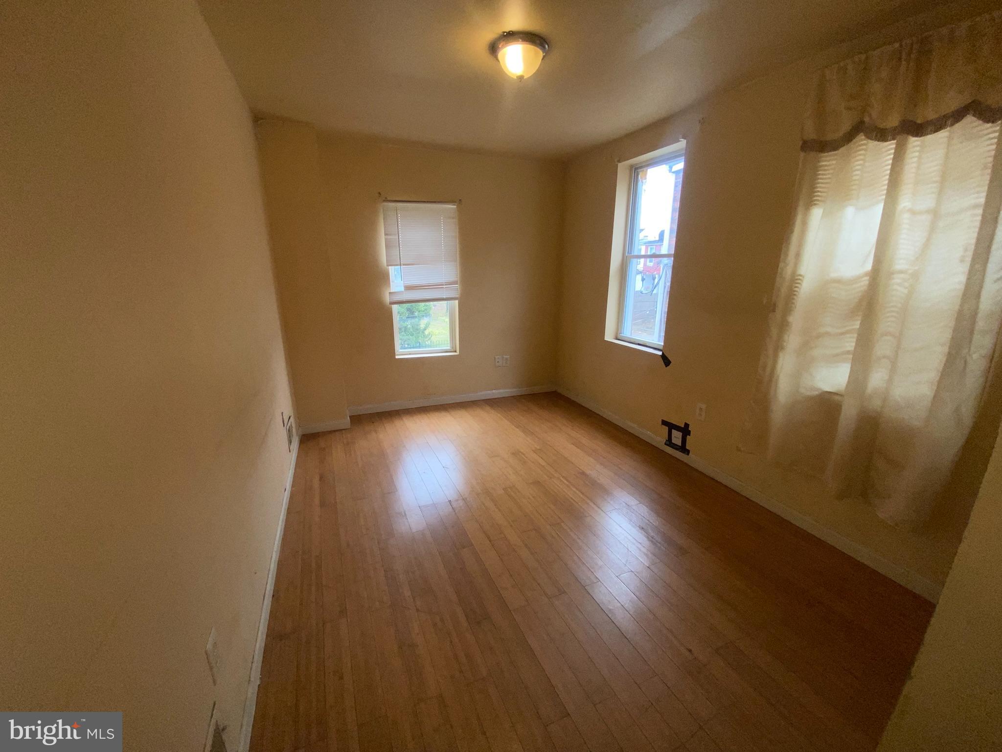 2221 Jefferson Street Baltimore, MD 21205 - Photo 15 of 29 a view of a room with wooden floor and windows