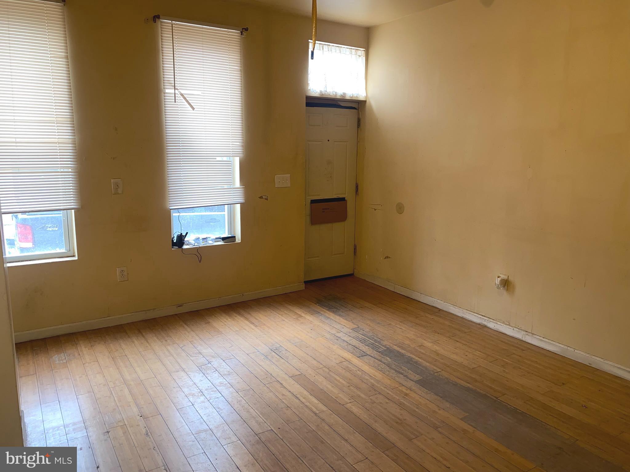 2221 Jefferson Street Baltimore, MD 21205 - Photo 5 of 29 an empty room with wooden floor and windows