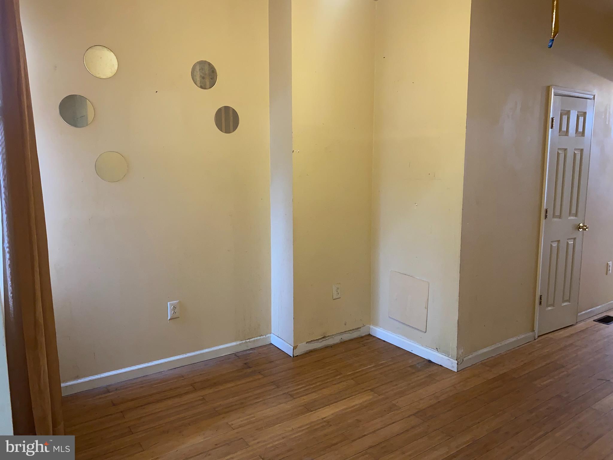 2221 Jefferson Street Baltimore, MD 21205 - Photo 6 of 29 an empty room with wooden floor and mirror