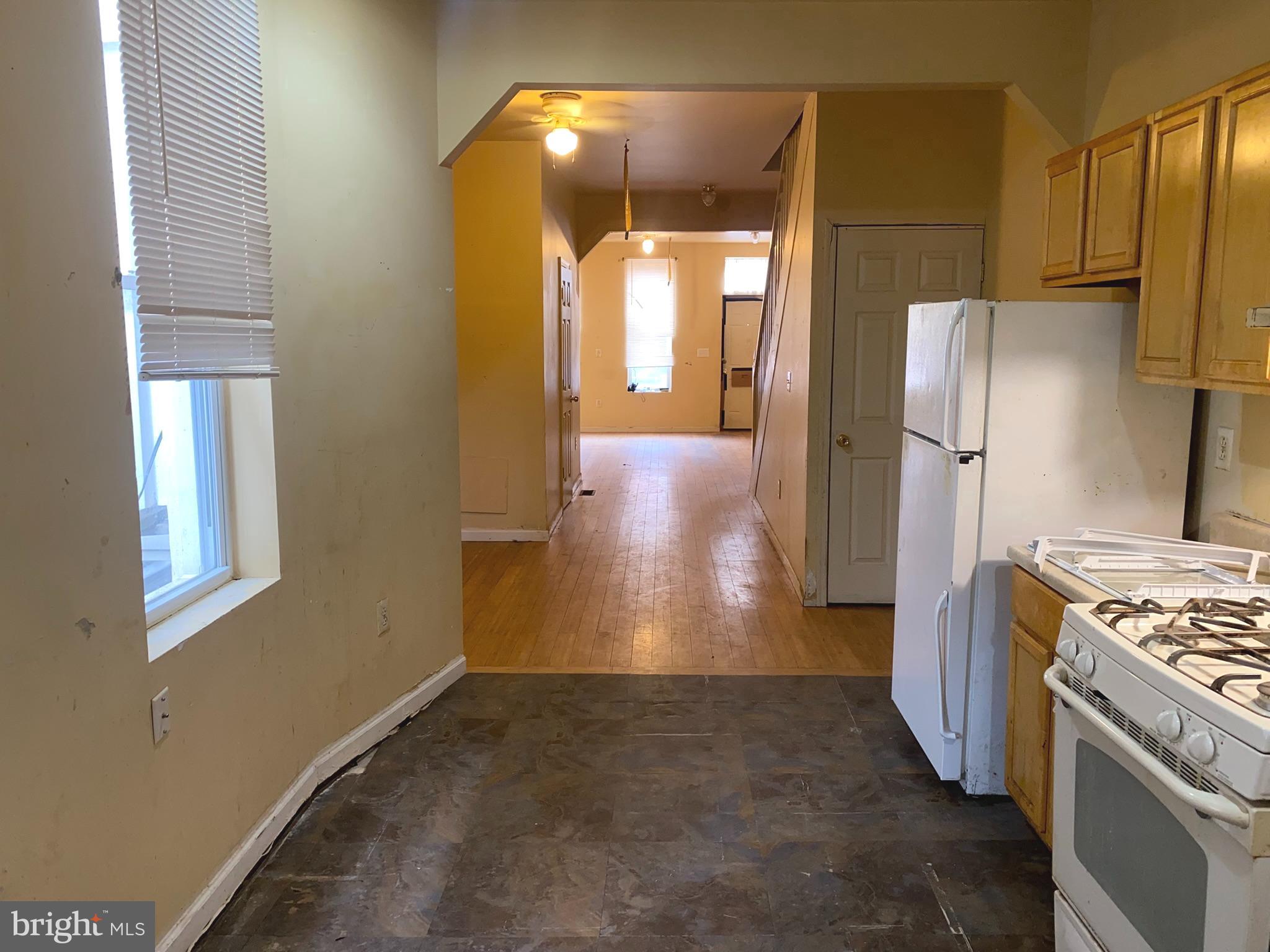2221 Jefferson Street Baltimore, MD 21205 - Photo 10 of 29 a view of a kitchen with a stove fridge and wooden floor