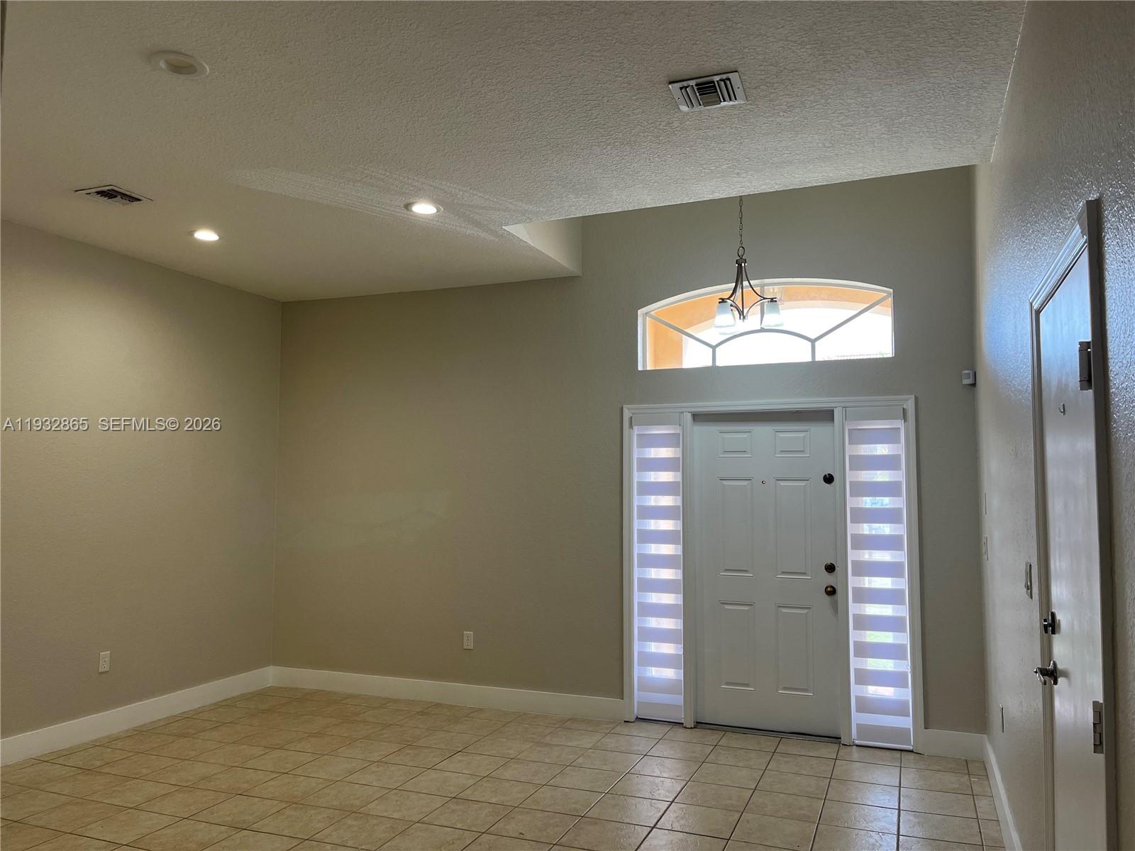 15205 Southwest 13th Terrace Miami, FL 33194 - Photo 4 of 12 an empty room with closet and chandelier