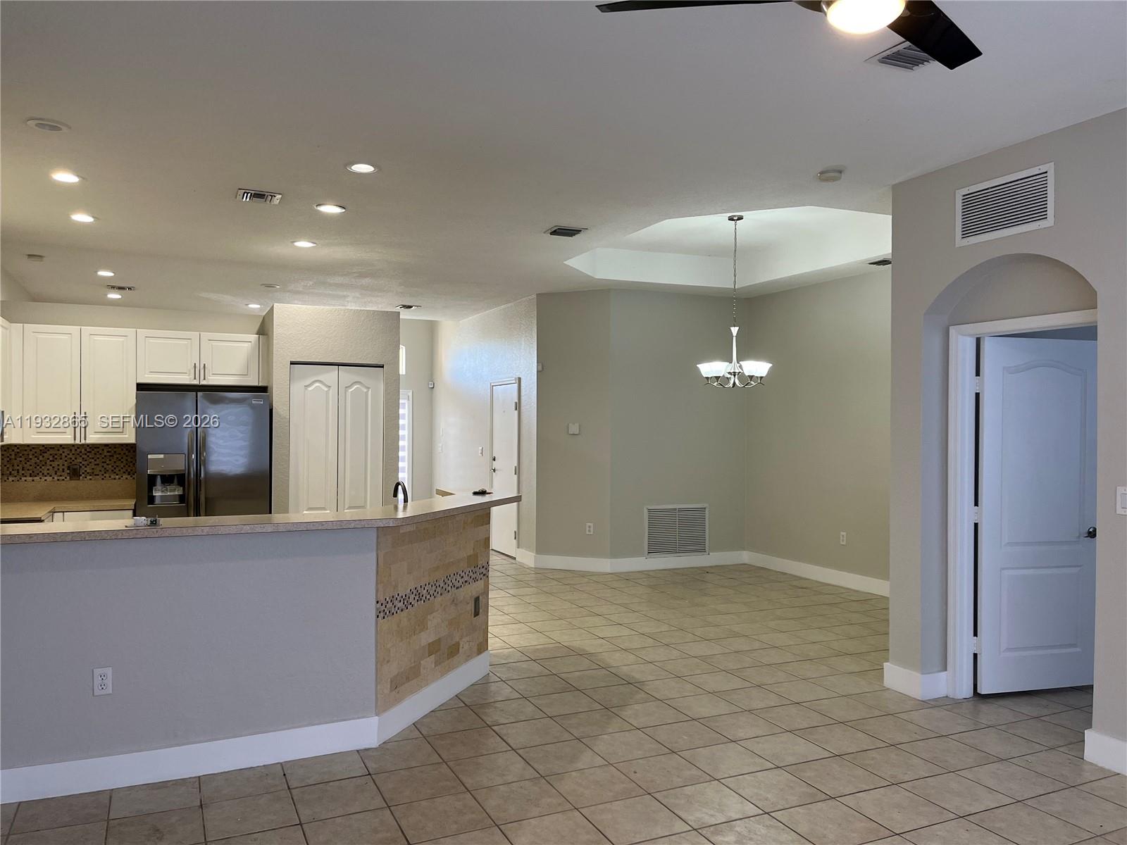 15205 Southwest 13th Terrace Miami, FL 33194 - Photo 7 of 12 a large kitchen with kitchen island a sink stainless steel appliances and cabinets