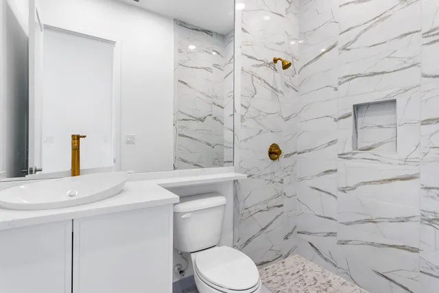 a bathroom with a sink toilet and shower