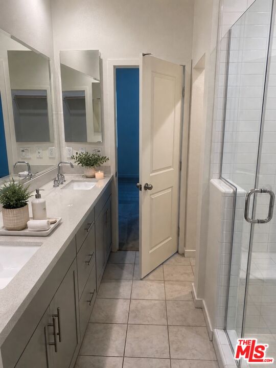 302 Limestone Lake Forest, CA 92610 - Photo 11 of 34 a bathroom with a sink a mirror and a shower