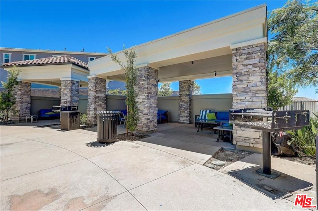 302 Limestone Lake Forest, CA 92610 - Photo 19 of 34 a view of a patio with a table and chairs under an umbrella