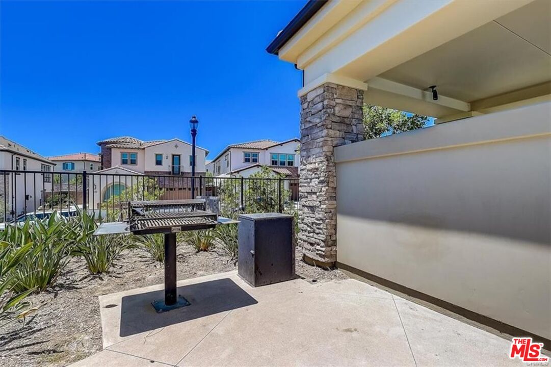 302 Limestone Lake Forest, CA 92610 - Photo 20 of 34 a view of a chairs and table in the backyard