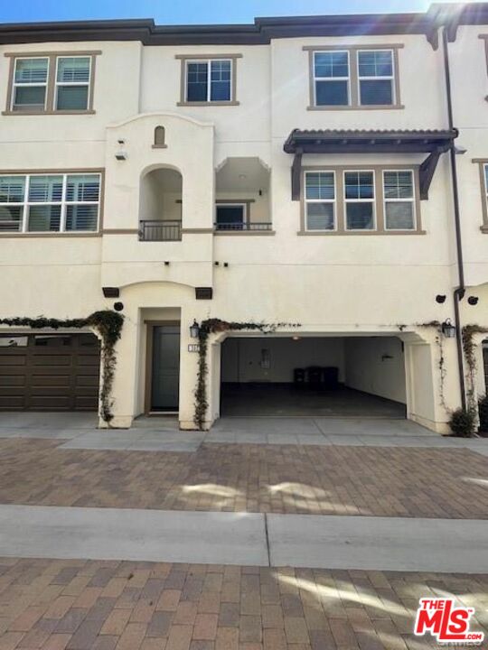 302 Limestone Lake Forest, CA 92610 - Photo 32 of 34 a view of a white house with large windows