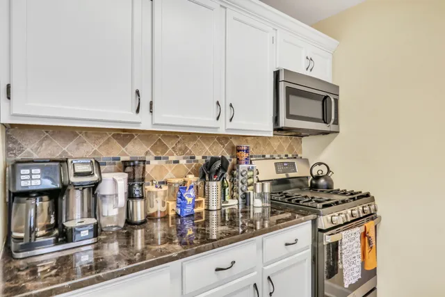 a kitchen with stainless steel appliances granite countertop a sink and cabinets