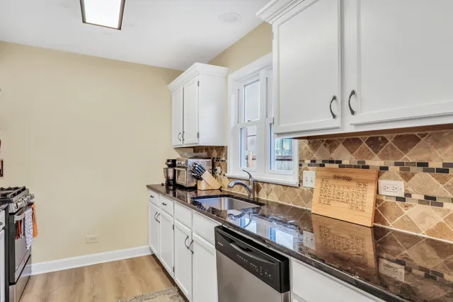 a kitchen with stainless steel appliances a sink a stove and a refrigerator