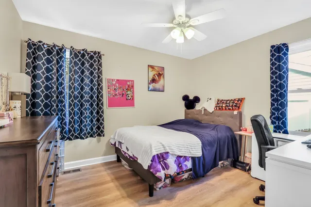 a bedroom with a bed and a chandelier