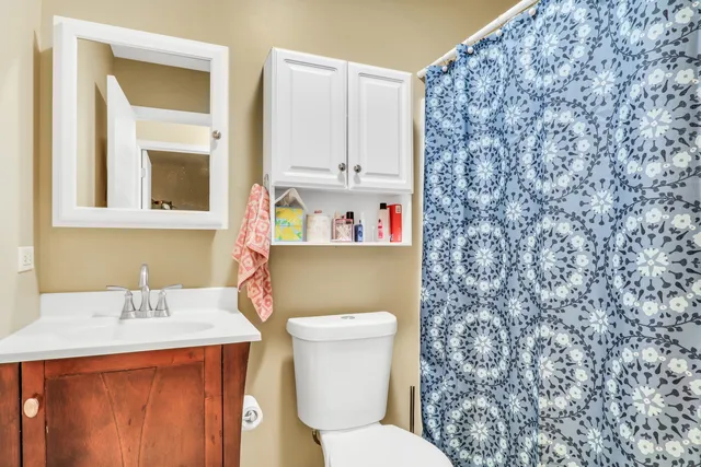 a bathroom with a sink a toilet and a mirror