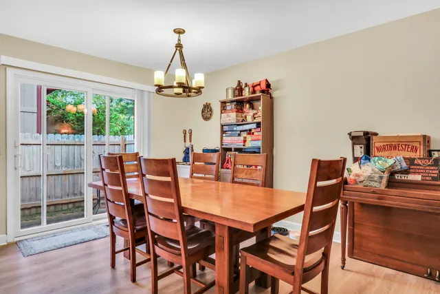 a dining room with furniture a chandelier and window