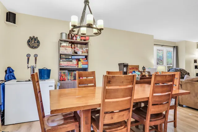 a view of a dining room with furniture and a chandelier