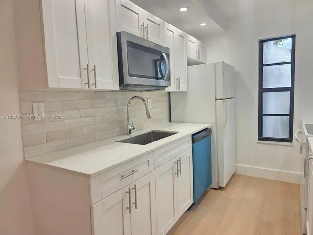 a kitchen with a sink stainless steel appliances and cabinets