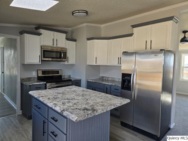 1025 Augusta Road Carthage, IL 62321 - Photo 8 of 25 a kitchen with kitchen island a counter space a refrigerator and microwave