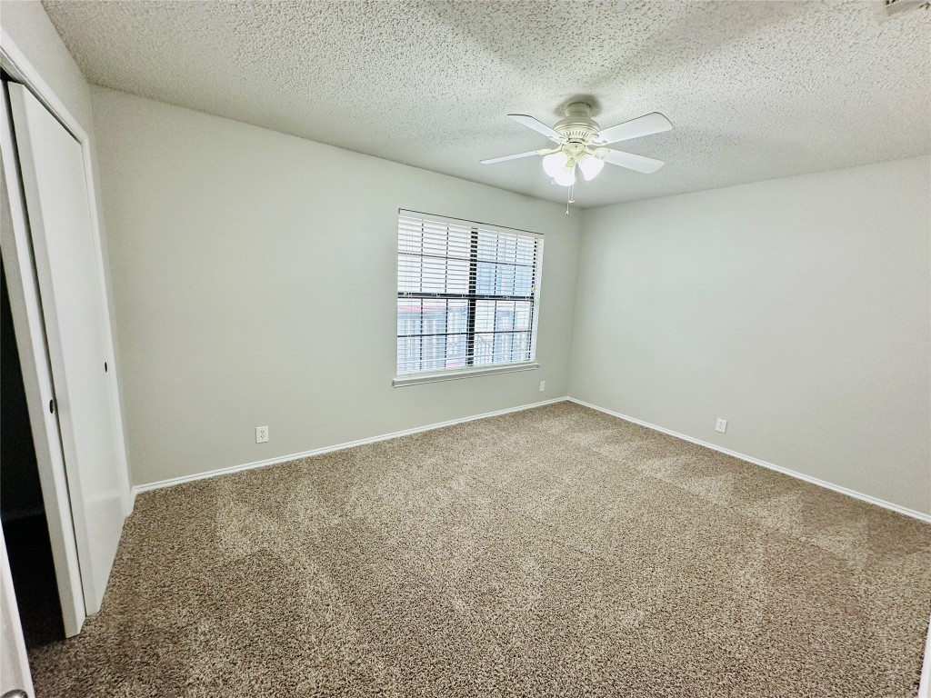 2215 Post Road, Unit 2028 Austin, TX 78704 - Photo 16 of 25 an empty room with windows and ceiling fan