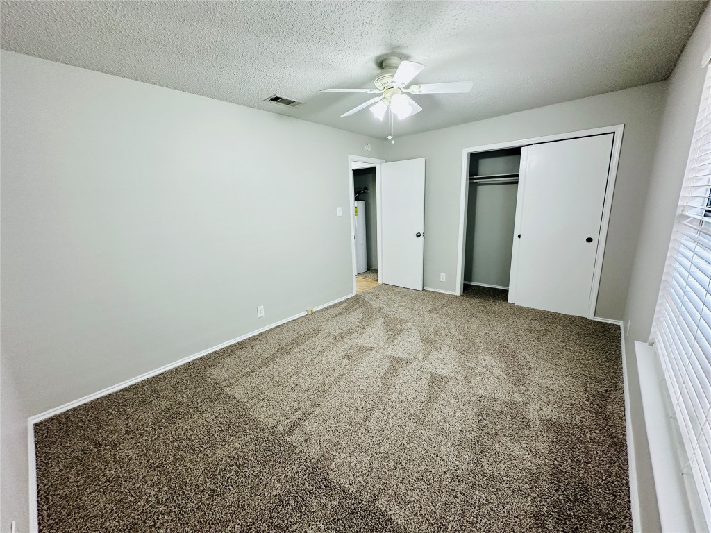2215 Post Road, Unit 2028 Austin, TX 78704 - Photo 17 of 25 an empty room with chandelier fan and windows