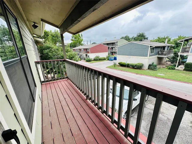a view of balcony with wooden floor