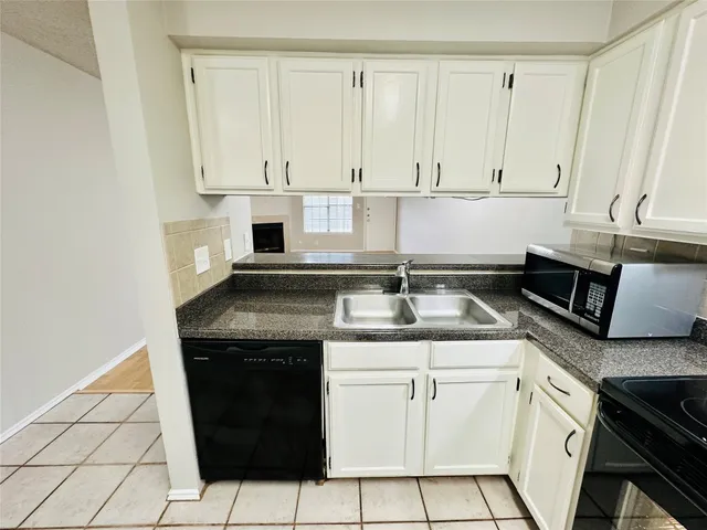 a kitchen with a sink stove and cabinets