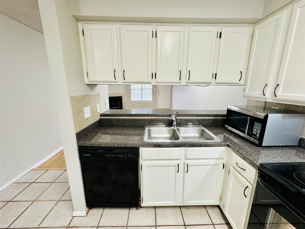 2215 Post Road, Unit 2028 Austin, TX 78704 - Photo 3 of 25 a kitchen with a sink stove and cabinets