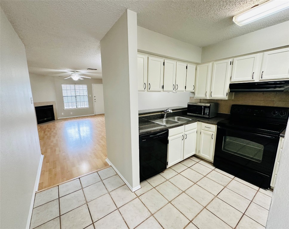 2215 Post Road, Unit 2028 Austin, TX 78704 - Photo 4 of 25 a kitchen with a sink a stove and cabinets