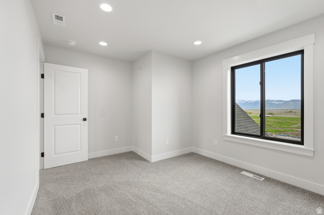2970 North Mahogany Vly Road Logan, UT 84341 - Photo 22 of 39 Spare room with a mountain view, light colored carpet, and recessed lighting