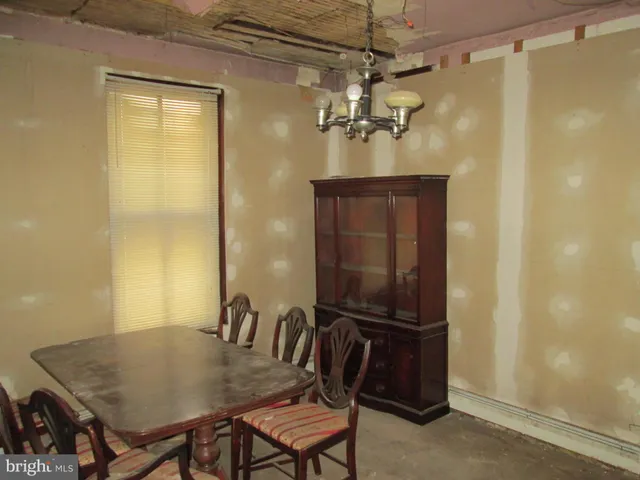 a view of a dining room with furniture and chandelier