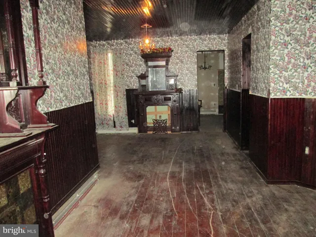 a view of living room with furniture and a fireplace