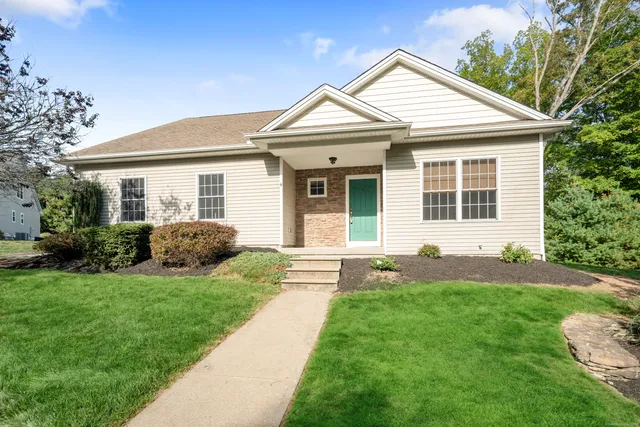 a front view of a house with a yard and porch