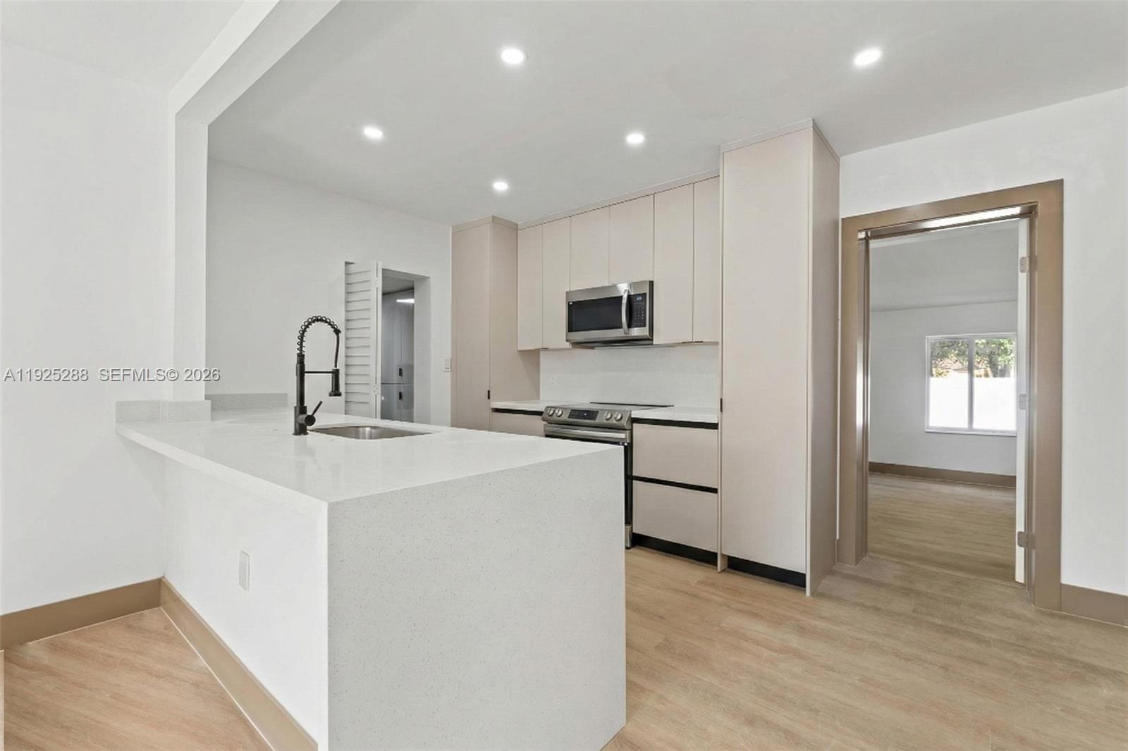 a kitchen with a sink appliances and cabinets