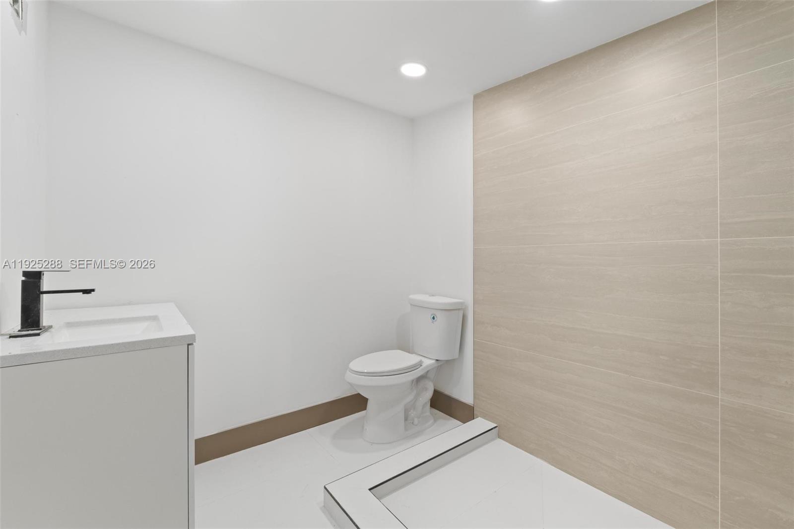 1453 Northwest 56th Street Miami, FL 33142 - Photo 19 of 29 a bathroom with a toilet and a sink