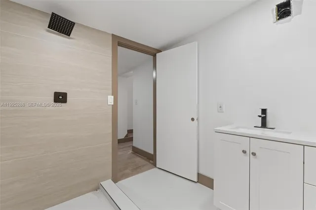 a bathroom with a sink and a mirror